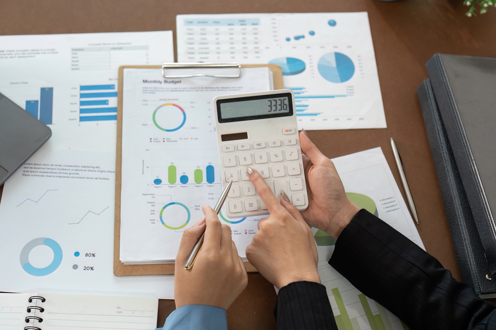Dallas-Fort Worth Medi-Share member reviewing tax documents and contribution statements with a calculator